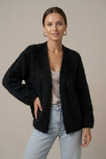 Woman wearing a fluffy open front cardigan in brushed knit over a cami and jeans - view 4