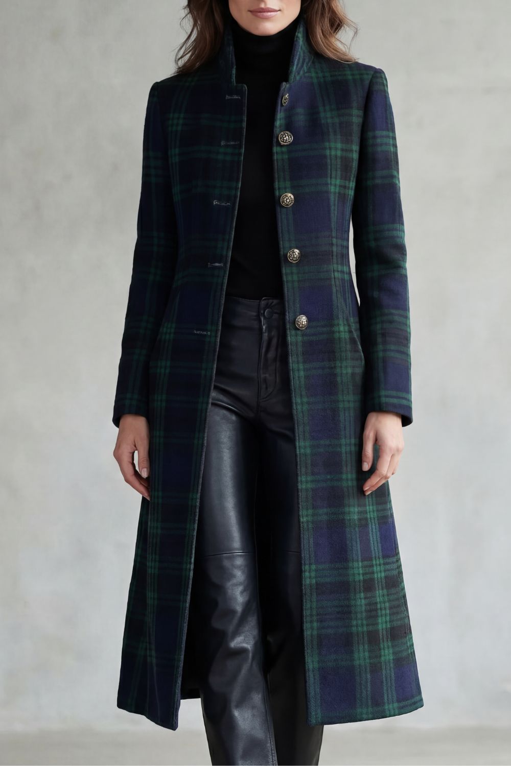 Woman wearing a long navy and green plaid stand collar coat with metal buttons