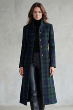 Woman wearing a long navy and green plaid stand collar coat with metal buttons - view 2