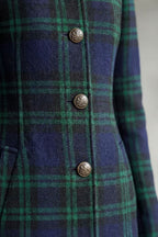 Woman wearing a long navy and green plaid stand collar coat with metal buttons - view 5