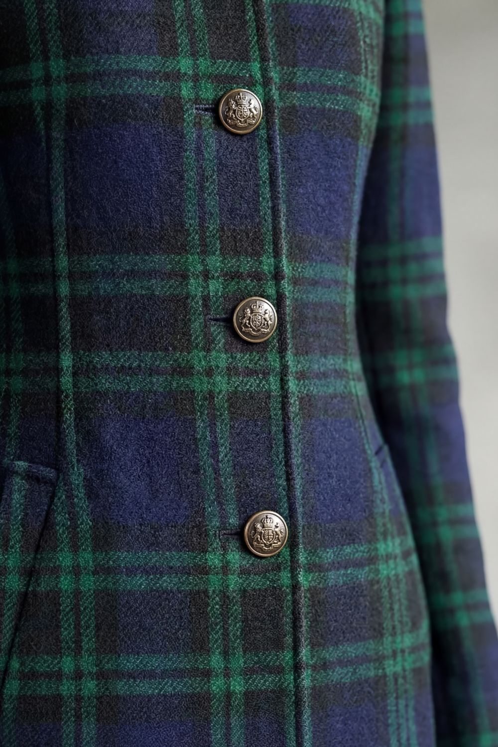 Woman wearing a long navy and green plaid stand collar coat with metal buttons - view 5