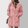 Woman wearing a plush quarter zip hooded sweater dress with kangaroo pocket and long sleeves