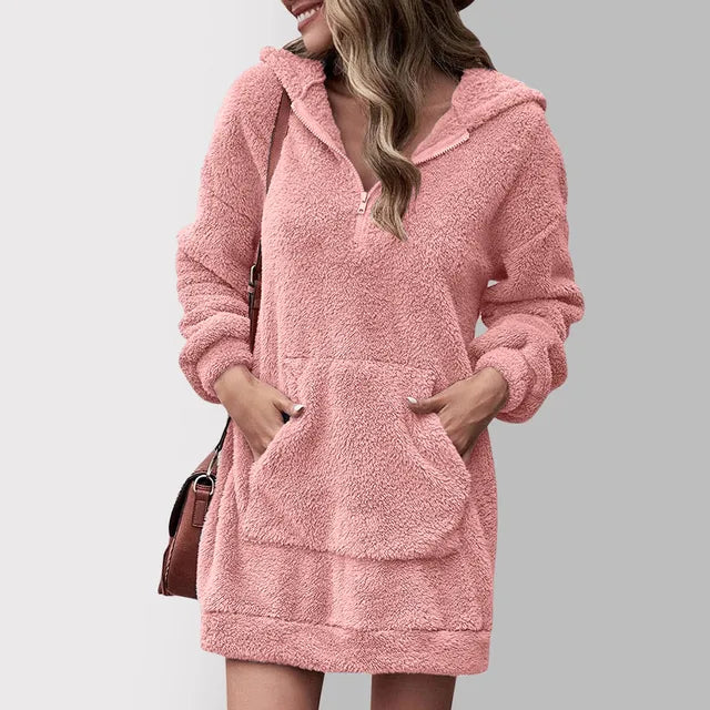 Woman wearing a plush quarter zip hooded sweater dress with kangaroo pocket and long sleeves
