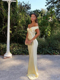 Woman wearing an off shoulder satin maxi wedding guest dress