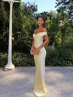 Woman wearing an off shoulder satin maxi wedding guest dress