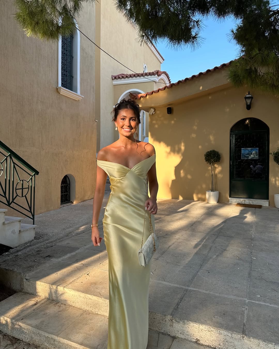 Woman wearing an off shoulder satin maxi wedding guest dress - view 4