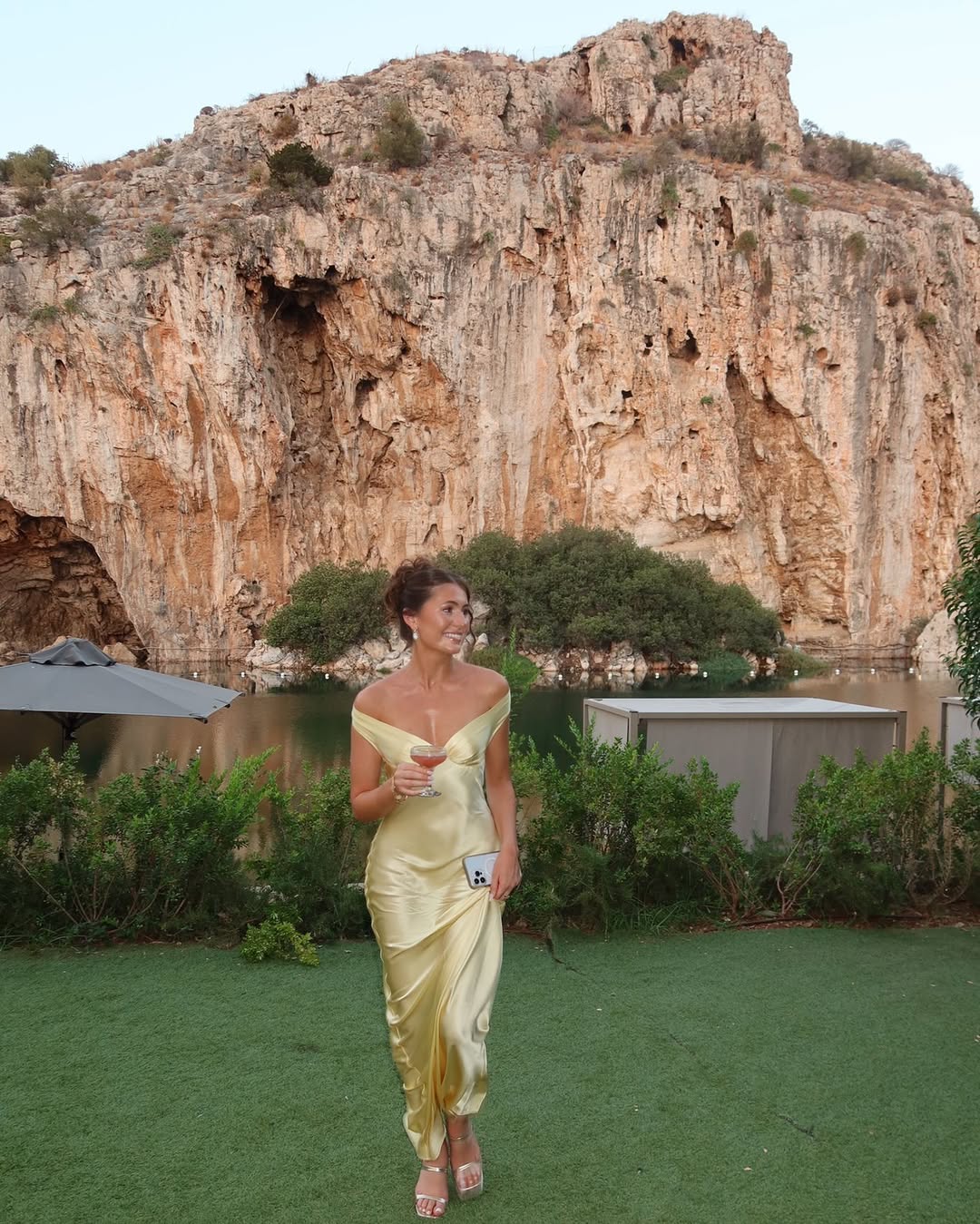 Woman wearing an off shoulder satin maxi wedding guest dress - view 5