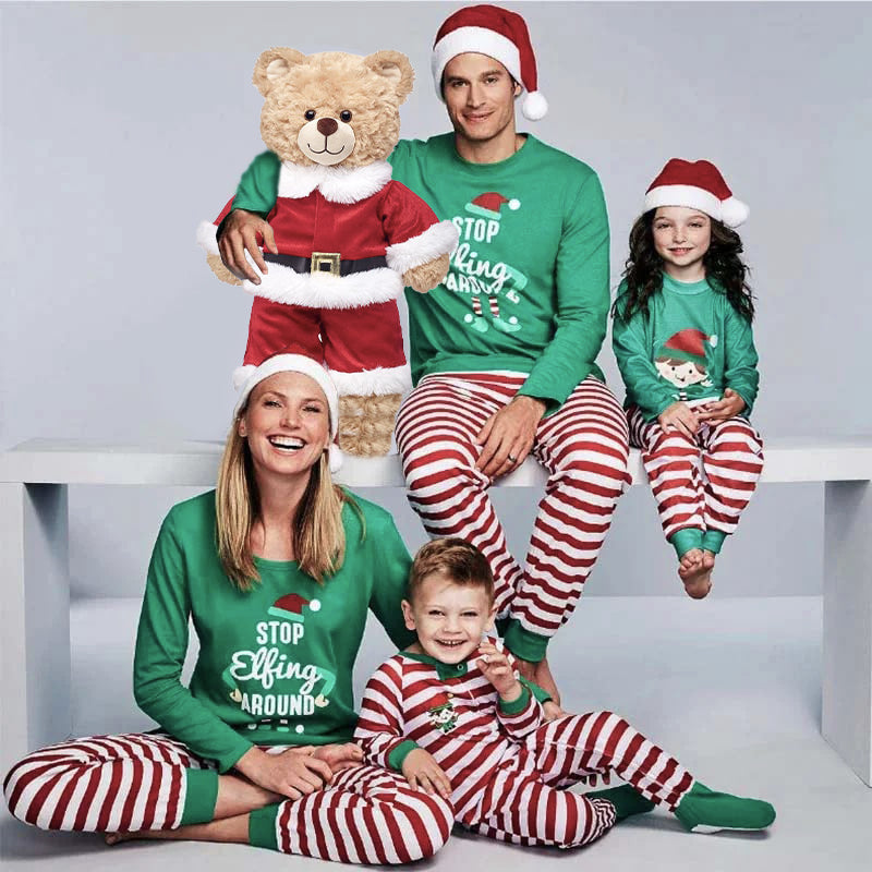 Family in matching green elf graphic tops and red and white striped Christmas pajama pants - view 2