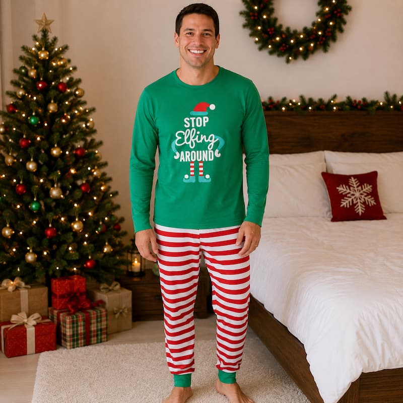 Family in matching green elf graphic tops and red and white striped Christmas pajama pants - view 3