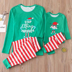 Family in matching green elf graphic tops and red and white striped Christmas pajama pants - view 7