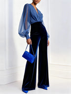 Model in a blue velvet evening jumpsuit with wide legs and sheer balloon sleeves - view 3