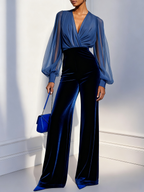 Model in a blue velvet evening jumpsuit with wide legs and sheer balloon sleeves - view 4