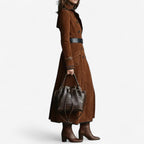 Woman wearing a long double breasted suede-look trench coat with contrast piping and flap pockets - view 2