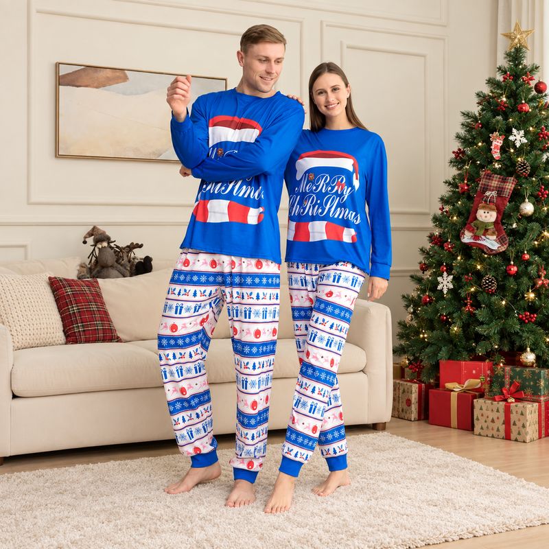 Matching family Christmas pajamas with blue Merry Christmas graphic top and holiday print pants - view 2