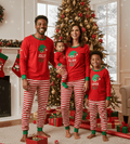 Matching family Christmas pajamas with red elf graphic top and red and white striped pants