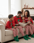 Matching family Christmas pajamas with red elf graphic top and red and white striped pants - view 10