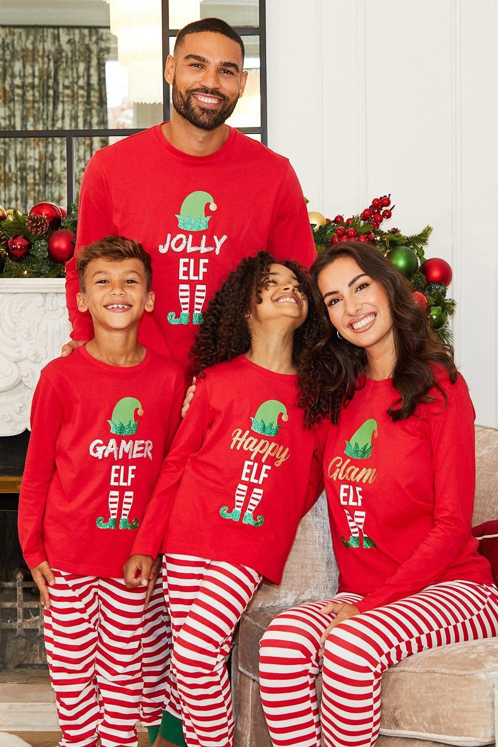 Matching family Christmas pajamas with red elf graphic top and red and white striped pants - view 3