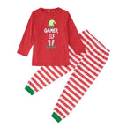 Matching family Christmas pajamas with red elf graphic top and red and white striped pants - view 4