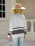 Woman wearing a relaxed colorblock quarter zip knit sweater with ring-pull half zip and ribbed cuffs - view 8