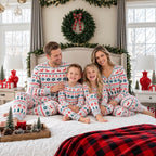 Family wearing matching Fair Isle Christmas pajamas with reindeer and snowflake print - view 14