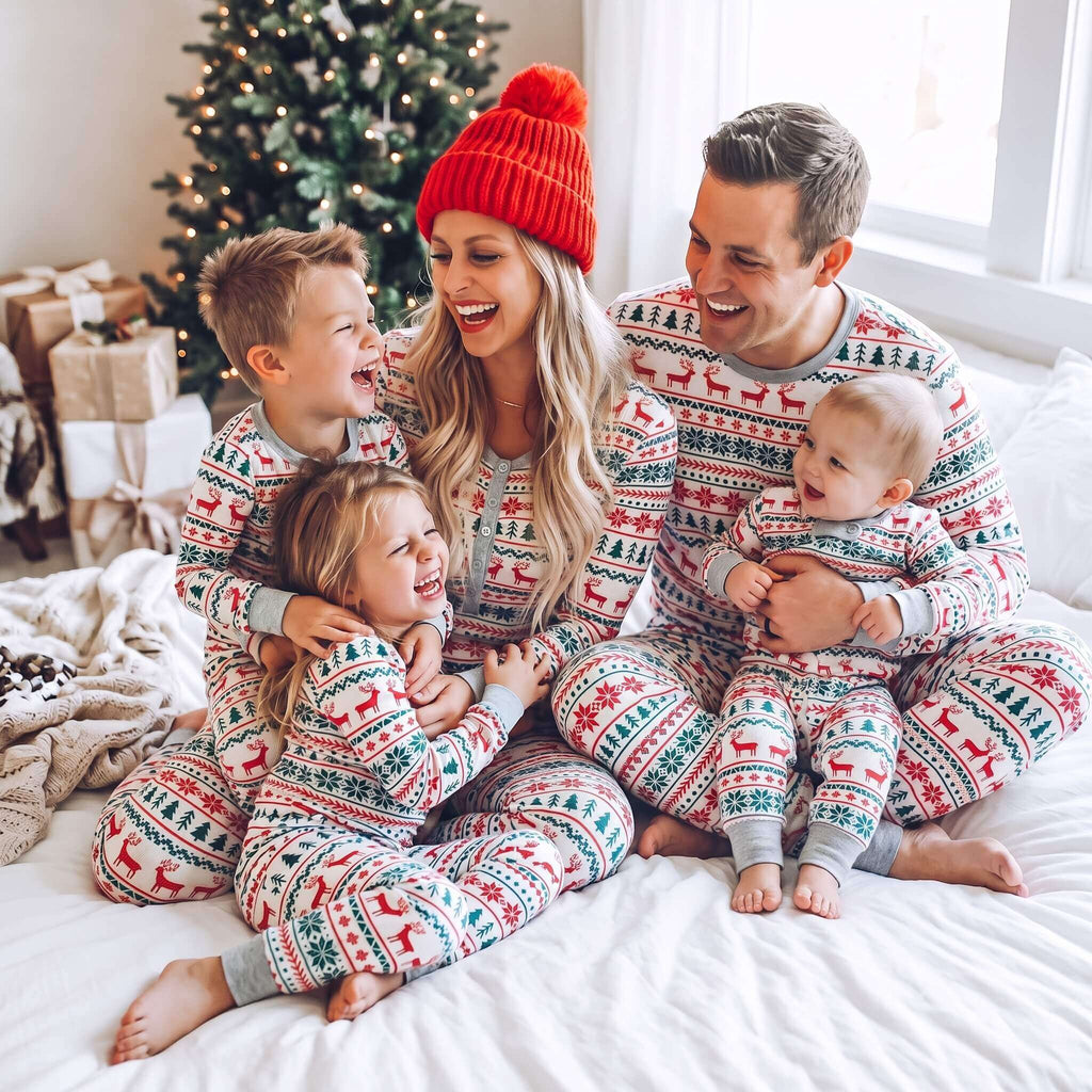 Family wearing matching Fair Isle Christmas pajamas with reindeer and snowflake print - view 4