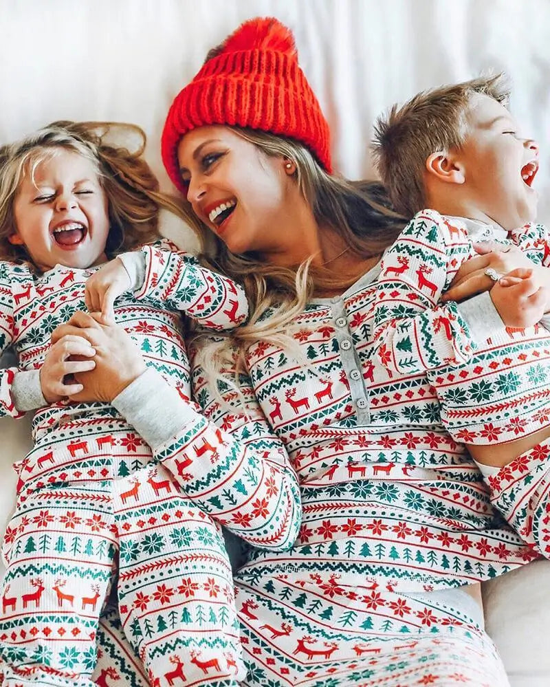 Family wearing matching Fair Isle Christmas pajamas with reindeer and snowflake print - view 5