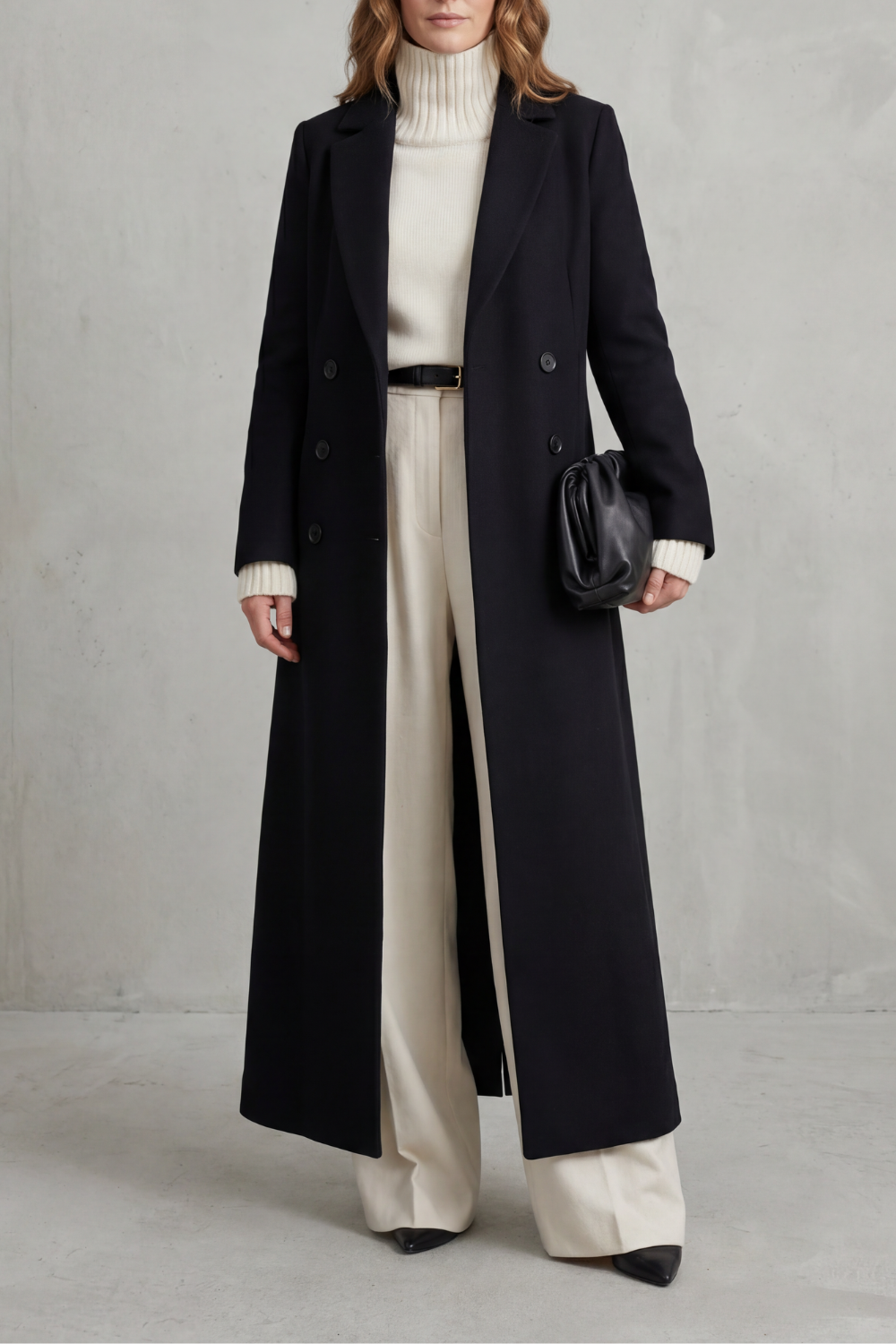 Woman wearing a long black double-breasted coat with notched lapels