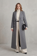 Woman wearing a long black double-breasted coat with notched lapels - view 10