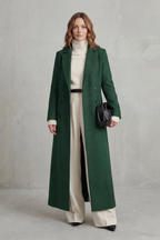Woman wearing a long black double-breasted coat with notched lapels - view 12