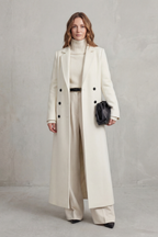 Woman wearing a long black double-breasted coat with notched lapels - view 14
