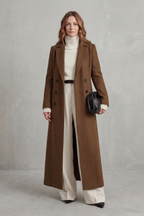 Woman wearing a long black double-breasted coat with notched lapels - view 6