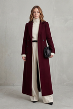 Woman wearing a long black double-breasted coat with notched lapels - view 8