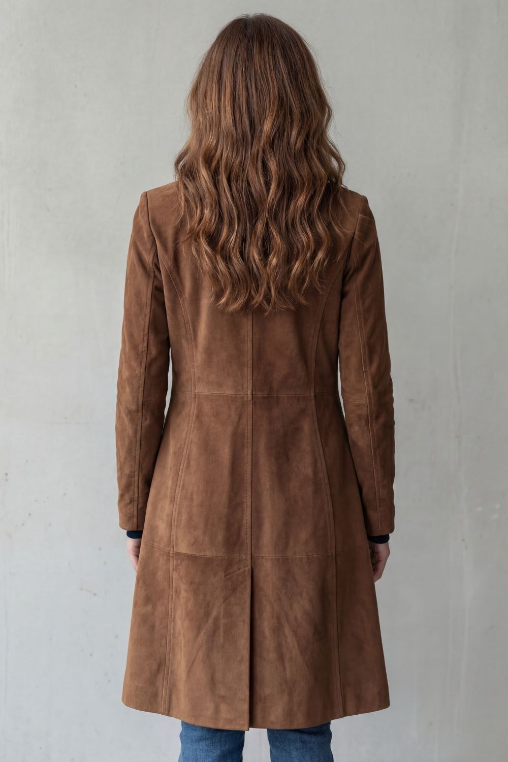 Woman wearing a longline faux suede coat with notched lapels and button front, styled with a turtleneck and jeans - view 3