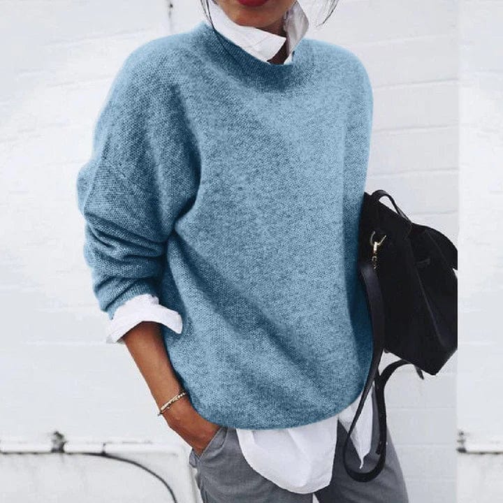 Oversized knit sweater with crew neck and dropped shoulders, layered over a white shirt
