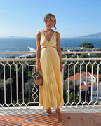 Yellow pleated satin A-line dress with V-neck and waist cutouts - view 2