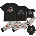 Family wearing matching black Merry Christmas tees and reindeer print jogger pajamas by a Christmas tree - view 6