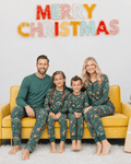 Family wearing matching green safari animal print Christmas pajamas