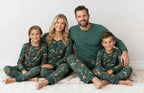 Family wearing matching green safari animal print Christmas pajamas - view 5