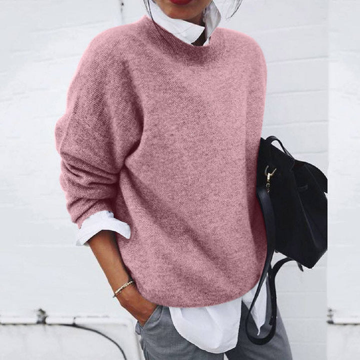 Women's oversized crew neck knit sweater layered over a white shirt
