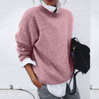 Women's oversized crew neck knit sweater layered over a white shirt