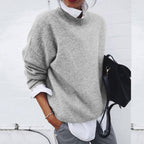 Women's oversized crew neck knit sweater layered over a white shirt - view 2