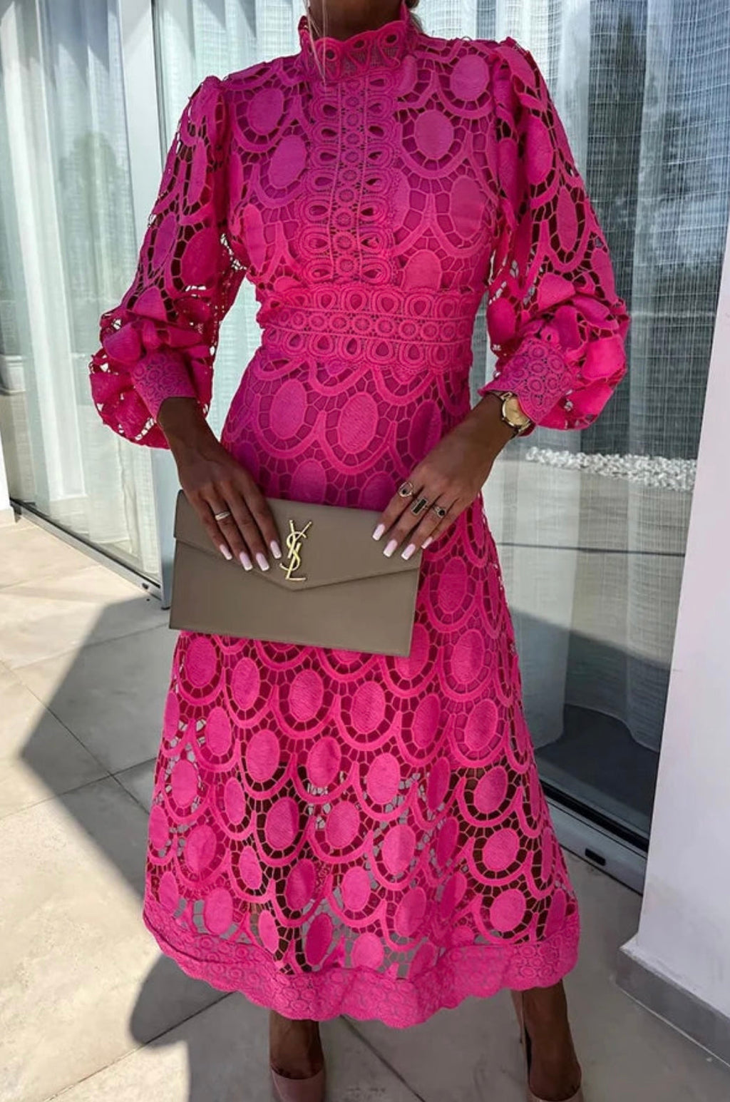 Woman wearing a long sleeve guipure lace midi dress with mock neck and puff sleeves