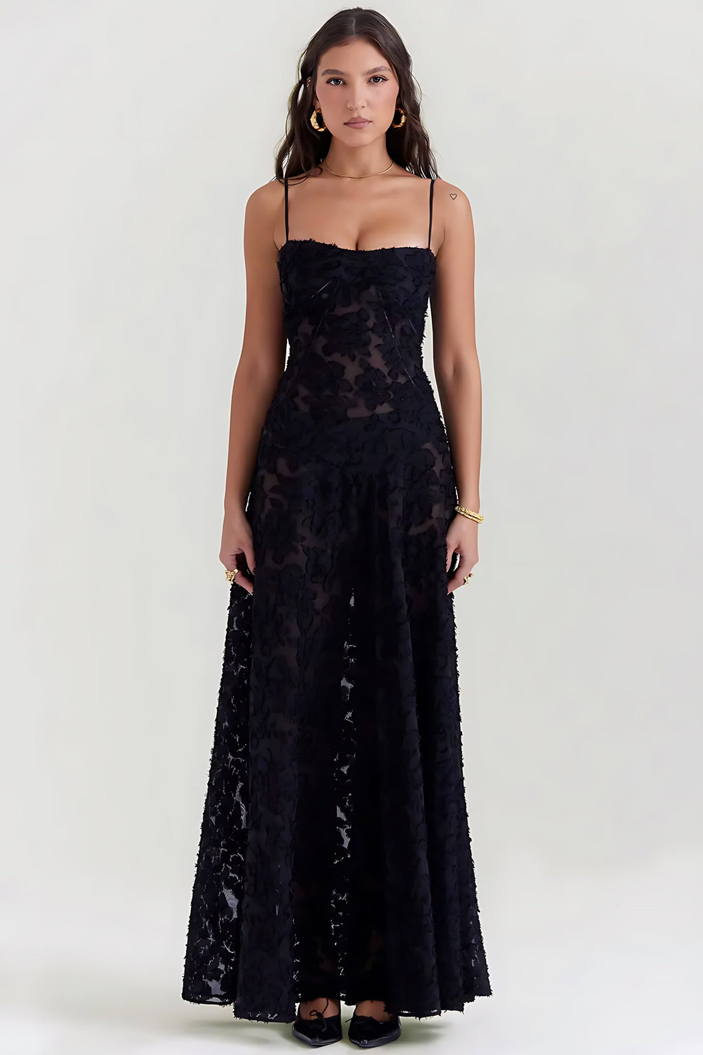 Sheer floral bustier maxi dress with spaghetti straps and flowing floor-length skirt
