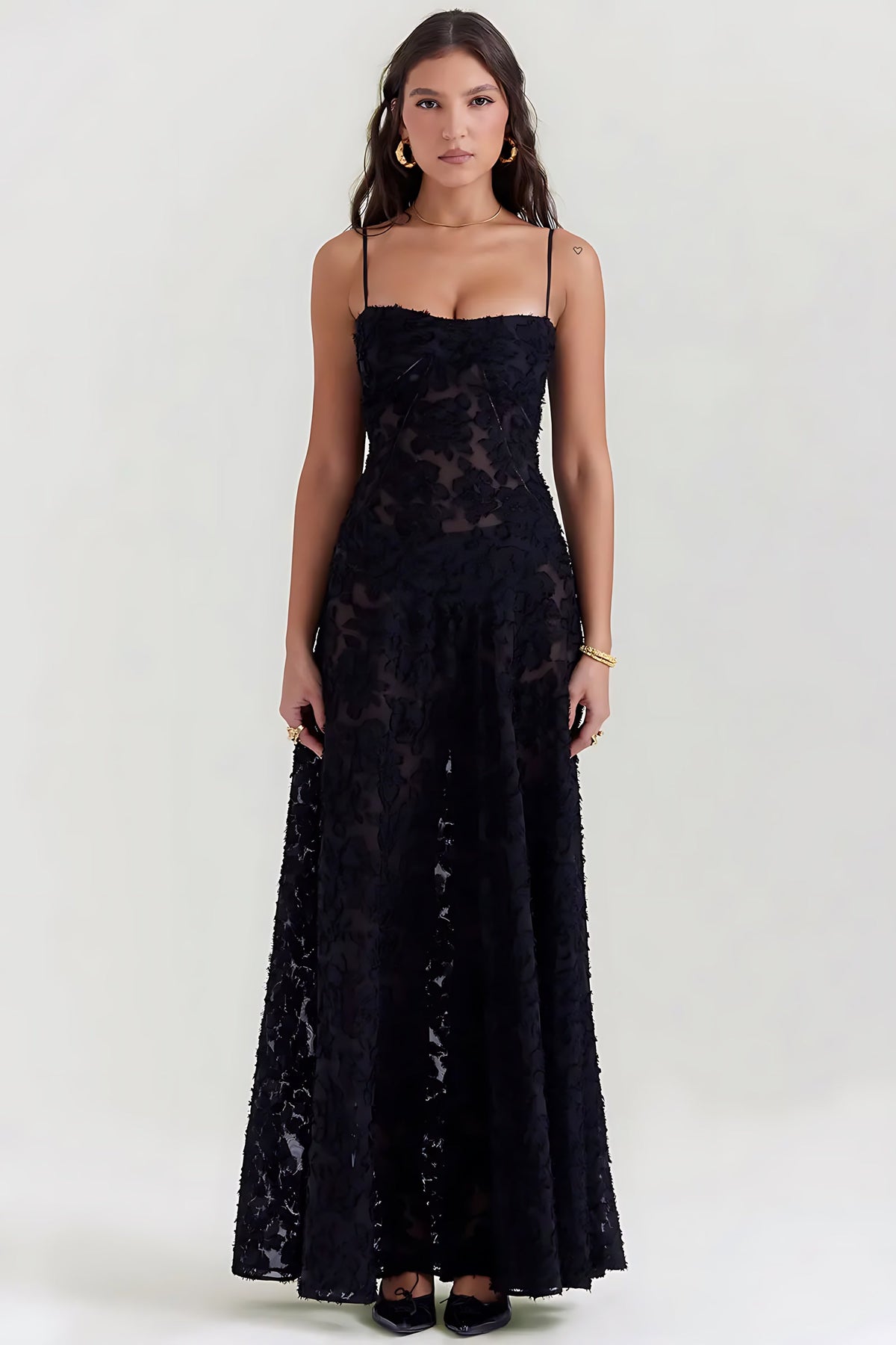 Sheer floral bustier maxi dress with spaghetti straps and flowing floor-length skirt