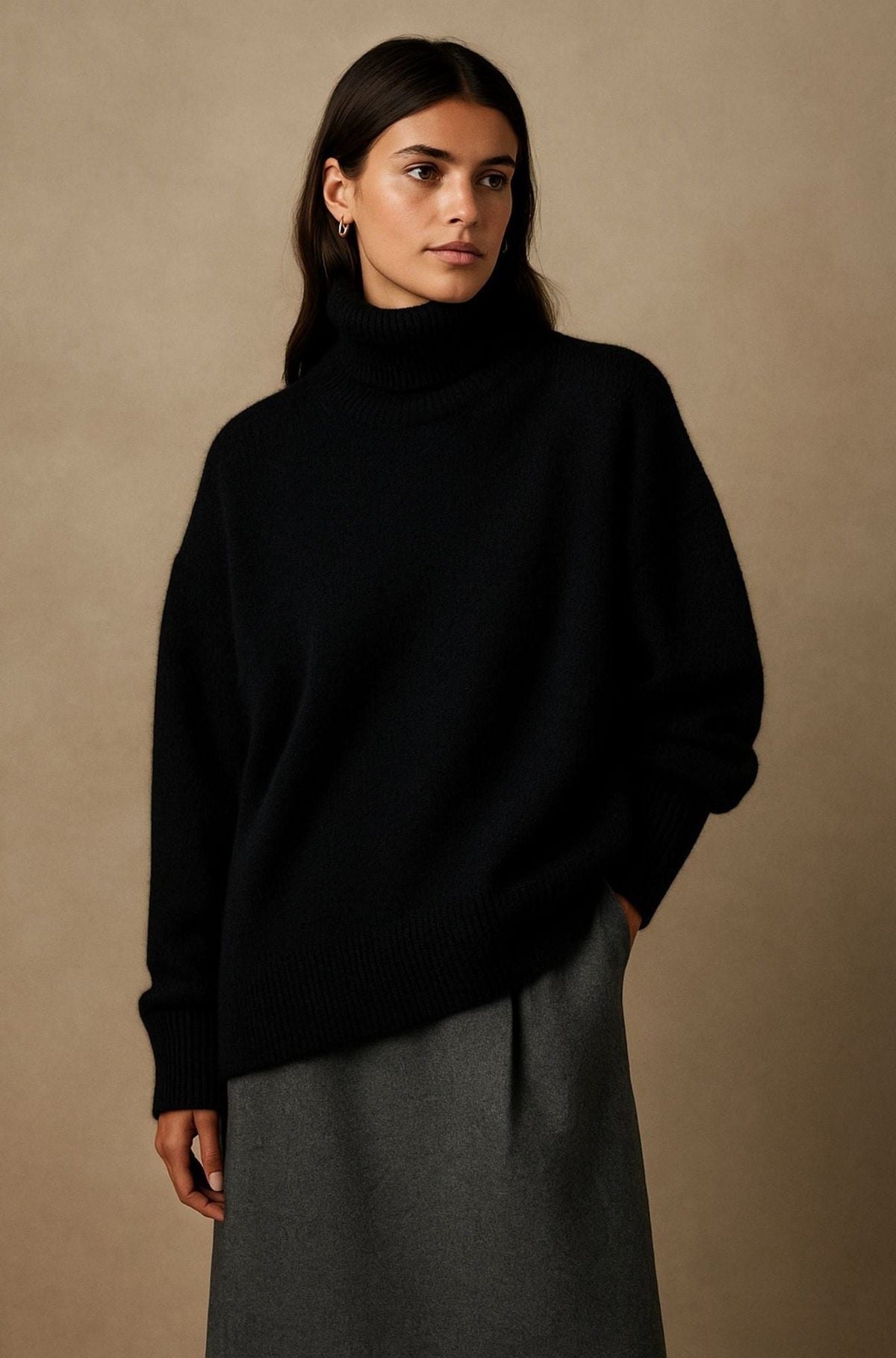 Woman wearing an oversized roll neck sweater in a soft brushed knit with ribbed cuffs