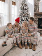 Family wearing matching reindeer print Christmas pajamas with gray ribbed cuffs - view 7