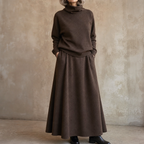 Woman in a brown knit turtleneck and A-line maxi skirt set outdoors