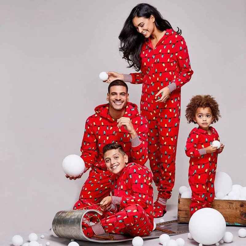Red hooded footed Christmas onesie with string-light bulb print worn by a matching family - view 2