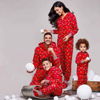 Red hooded footed Christmas onesie with string-light bulb print worn by a matching family - view 2