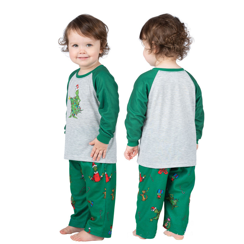 Matching family Christmas pajamas with gray raglan top, green sleeves and green character print pants - view 12